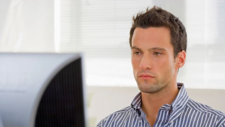 Building inspector reviewing upcoming recurring inspections with online software