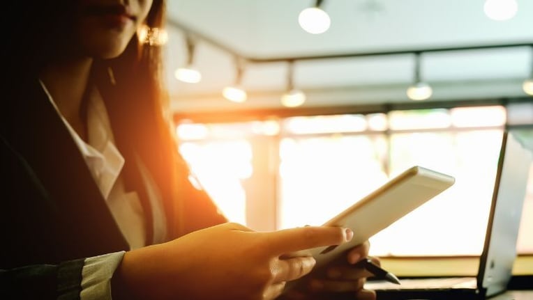 Government official reviewing budget on tablet for permitting software