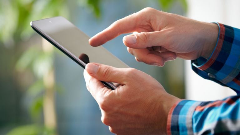 Man using tablet in the field to inspect vacation rental property